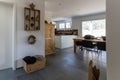 Interior view of an elegant house with black tile floor and white plaster walls and wooden furniture and decorative articles