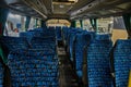 Interior view of an empty bus with rows of blue patterned seats, ready for passengers. Ideal for concepts of travel, Royalty Free Stock Photo