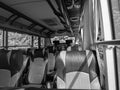 Interior view of an empty passenger bus showing seats and overhead compartments Royalty Free Stock Photo