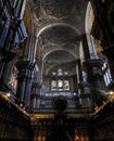 Interior view of the grand Cathedral of Malaga, Spain, featuring a high-arched ceiling