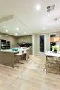 Interior view of a house with wooden floor and kitchen next to the dinning room Royalty Free Stock Photo