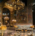 Interior view of the main hall of the Alexander Nevsky Cathedral with votive candles and images