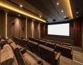 Cinema interior with rows of seats and a large blank screen illuminated theater auditorium Royalty Free Stock Photo