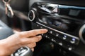 Interior view of a modern new car. Woman`s hand and climatronic or air conditioner system concept Royalty Free Stock Photo