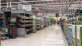 Interior view of modern supermarket with food chillers and self service checkouts