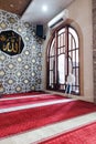 An interior view of a mosque featuring a beautifully decorated wall with Islamic Royalty Free Stock Photo