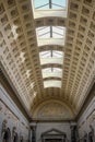 Interior view of an ornate, historic Vatican Museum with elaborate columns and an ornate ceiling