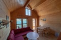 An interior view of a small resort house next to a coastline, fjord, beach. Cosy looking and comfortable