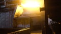 Interior view of steel mill with huge ladle of burning metal alloy. Footage. View of open-hearth furnace with bright