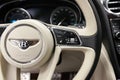 Interior view with steering wheel and buttons of luxury very expensive new black Bentley Bentayga car stands in the washing box