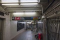 Interior view of subway station where homeless man sleeps on floor. New York,