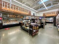 Interior view of a supermarket with aisle with shelves bakery and vegetable variety of products