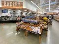 Interior view of a supermarket with aisle with shelves bakery and vegetable variety of products