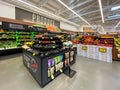 Interior view of a supermarket with aisle with shelves full of fruit and vegetable variety of products