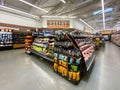 Interior view of a supermarket with aisle with shelves full of fruit and vegetable variety of products