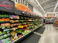 Interior view of a supermarket with aisle with shelves full of fruit and vegetable variety of products