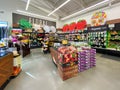 Interior view of a supermarket with aisle with shelves full of fruit and vegetable variety of products