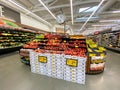 Interior view of a supermarket with aisle with shelves full of fruit and vegetable variety of products