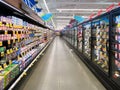 Interior view of a supermarket with aisle with shelves full of variety of products