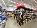 Interior view of a supermarket with alcohol aisle with shelves full of variety of products