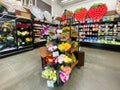 Interior view of a supermarket with flower aisle with shelves full of variety of products