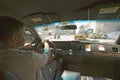 Interior view of taxi cab and driver steering through New York City, Manhattan streets, New York