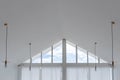 Interior view of triangle shape window with white curtain and cloud sky Royalty Free Stock Photo