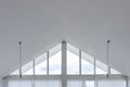 Interior view of triangle shape window with white curtain and cloud sky Royalty Free Stock Photo