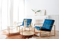 Interior view of two elegance comfortable armchair and gold glass coffee table in living room