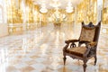 Interior view of vintage wooden chair in luxury mirror room or hall decorated with chandelier Royalty Free Stock Photo