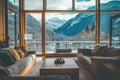 Interior view Window overlooking snowcovered mountains, cozy sofas, & square coffee table Royalty Free Stock Photo