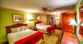 Interior of a vintage hotel room with two king beds