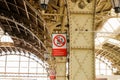 Interior of the Vitebsk railway station, sunflare. Red vertical Warning sign, translation: Do not leap from platform