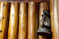 Interior wall of a log cabin with vintage rusty lantern. Royalty Free Stock Photo