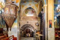 The interior with walls painted on a religious theme in main hall of Greek Orthodox Church of Annunciation in Nazareth old city in Royalty Free Stock Photo