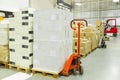 Interior of a warehouse with manual forklift pallet stacker truck equipment, boxes. Royalty Free Stock Photo