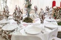 Interior of a wedding tent decoration ready for guests. Served round banquet table outdoor in marquee decorated flowers Royalty Free Stock Photo