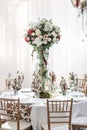 Interior of a wedding tent decoration ready for guests. Served round banquet table outdoor in marquee decorated flowers Royalty Free Stock Photo