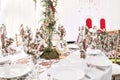 Interior of a wedding tent decoration ready for guests. Served round banquet table outdoor in marquee decorated flowers Royalty Free Stock Photo