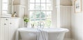 Interior of white bathroom with a bathtub and a mirror and window view