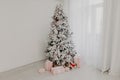 Interior with white Christmas tree for the new year with gifts for the holiday Royalty Free Stock Photo