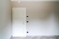 White door closed on gray wall