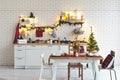 Interior white kitchen with lights and red christmas decorations Royalty Free Stock Photo