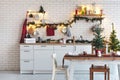 Interior white kitchen with lights and red christmas decorations Royalty Free Stock Photo