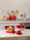 Interior white kitchen with kitchen tools and red crockery. Royalty Free Stock Photo