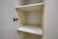 Interior of white plastic cabinet or clothing wardrobe with many empty shelves with open doors. Furniture design and installation