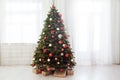 Christmas interior of the white room green Christmas tree with red gifts for the new year decor winter holiday Royalty Free Stock Photo