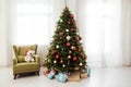 Christmas interior of the white room green Christmas tree with red gifts for the new year decor winter holiday Royalty Free Stock Photo