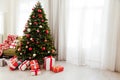 Christmas interior of the white room green Christmas tree with red gifts for the new year decor winter holiday Royalty Free Stock Photo