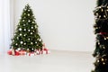 Christmas interior of the white room green Christmas tree with red gifts for the new year decor winter holiday Royalty Free Stock Photo